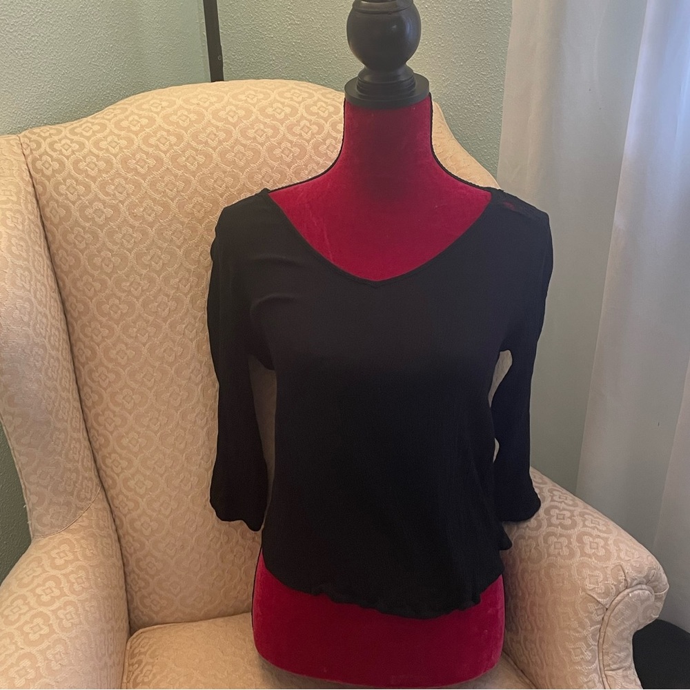 Women’s black v-neck blouse with 3/4 sleeve.